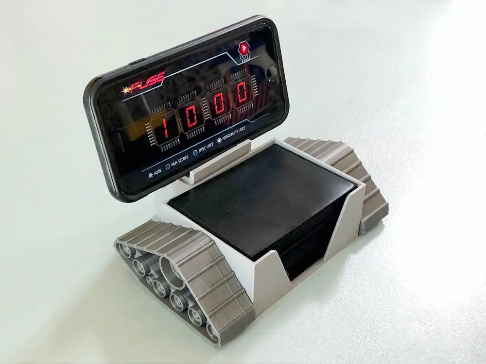 A 3D-printed robot I designed to hold the phone (timer app) and cards!