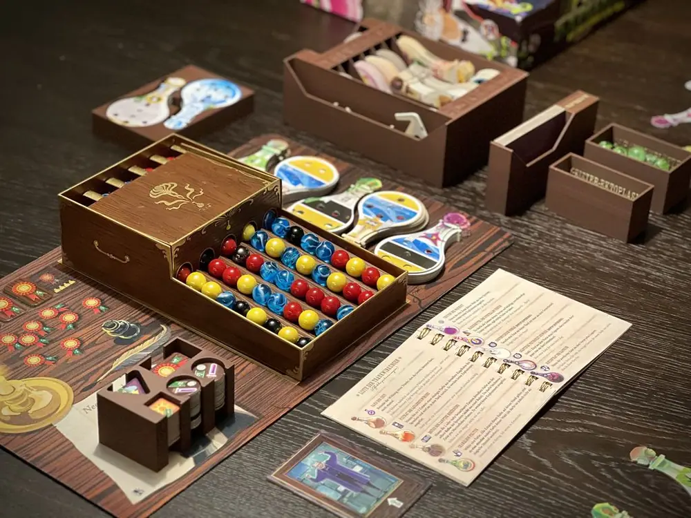 Upgraded Premium Edition with a painted dispenser, custom marbles, a playmat, a custom 3D insert made with wood filament and a complete and compact 4-player rulebook for the base game, all expansions, and promos.