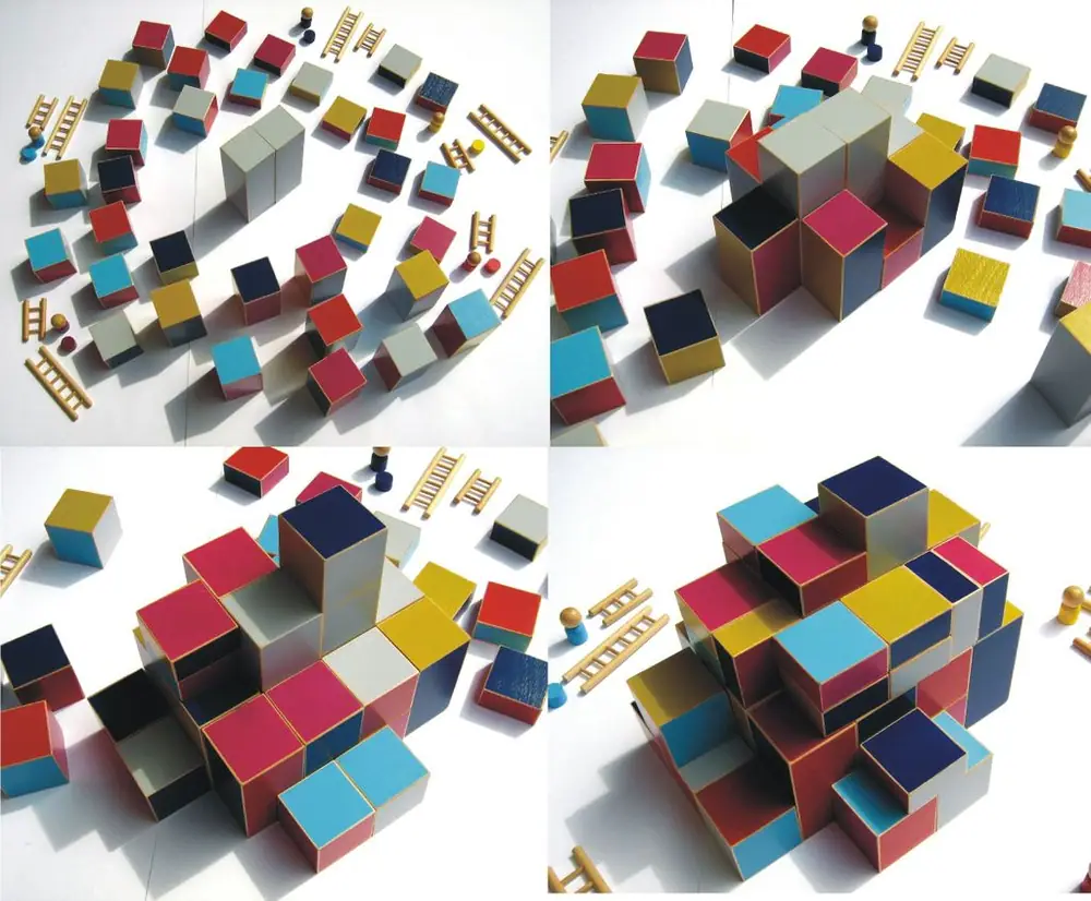 Building phase before the actual game: Starting with the two large grey blocks in the middle, all players create a huge wooden block-tower hiding the central ones