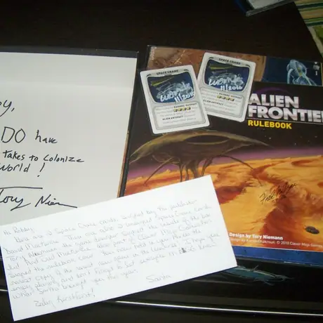 Rulebook, cover and 2 cards signed by the game designer and the publishers.  A gift from my Secret Santa 2010 :)