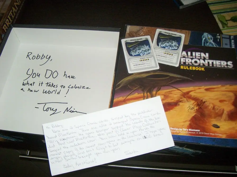 Rulebook, cover and 2 cards signed by the game designer and the publishers.  A gift from my Secret Santa 2010 :)
