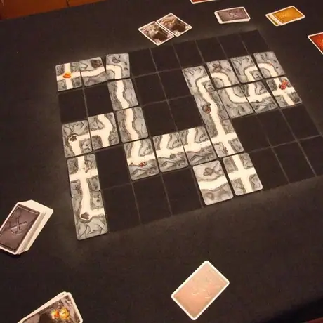 I saw a need for a play mat for the game to ease setup and play.  I found a suitable cloth of polar-fleece material, laid out a grid pattern of standard cheap playing cards, and using a white aerosol spray paint I lightly dusted over the cards leaving thi